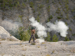 Soldier shooting a grenade launcher with smoke