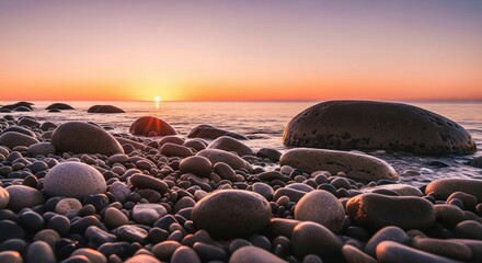 Obraz premium Tranquil evening vista of a rocky shoreline bathed in the soft, warm glow of a pastel sunset.