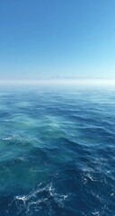 Fototapeta premium Calm ocean surface meeting a hazy, distant horizon
