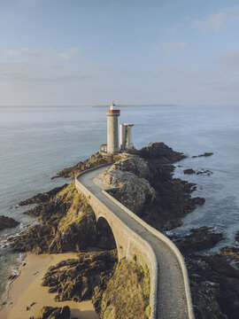 Aerial view of the striking Minou lighthouse stands proudly on a rocky islet, linked by a slender bridge, against the vast expanse of the azure sea, Plouzan&Atilde;&copy;, Finist&Atilde;&uml;re, France.