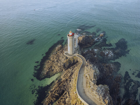 Aerial view of the Petit Minou lighthouse standing guard on the rugged, rocky Pointe du Minou promontory against the turquoise sea, Plouzan&Atilde;&copy;, Finist&Atilde;&uml;re, France.