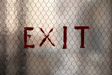 Red Exit sign on glass background