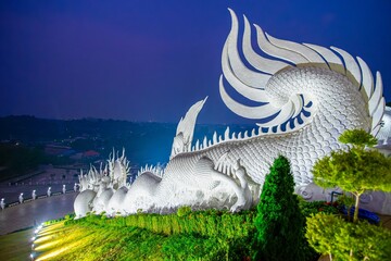 Traditional Naga sculptures along Wat Huai Pla Kang Temple steps, Chiang Rai, Thailand