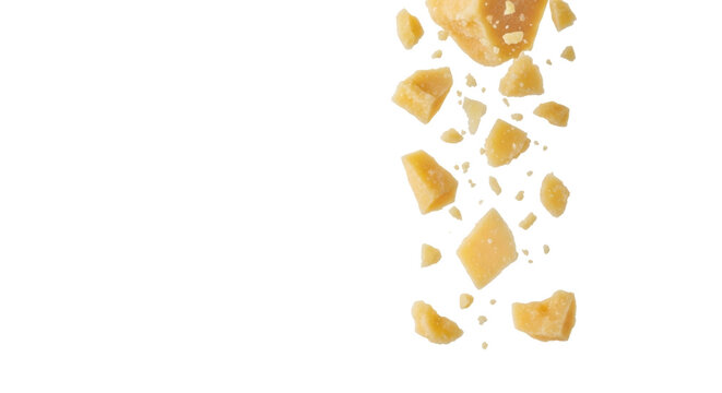 Golden-yellow parmesan cheese pieces and translucent flakes dynamically falling against a transparent studio background with copy space, high-key lighting. Culinary ingredient concept