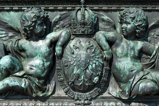 Close-up of bronze detail of angels and royal crest