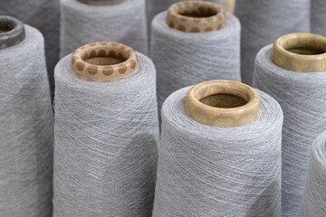 Group of large spools of thread of gray color