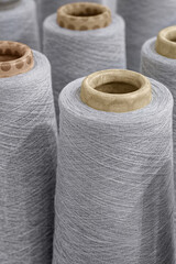 Group of large spools of thread of gray color