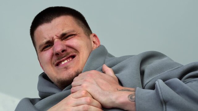 Heart attack and chest pain in a middle-aged man.
The man suddenly has heart pain and is holding his chest with his hands.
Chest pain due to heart problems