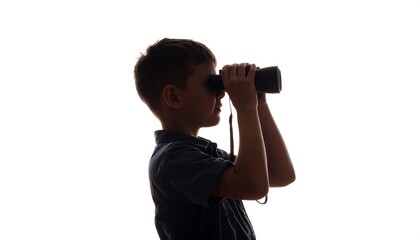 Silhouette of a boy looking through binoculars