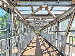 Steel and glass pedestrian bridge connects urban spaces with modern design and functionality
