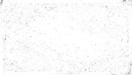 A white surface with scattered dark speckles and abstract lines creating a textured pattern.
