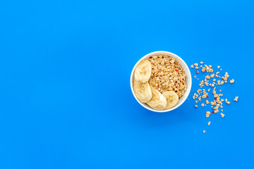 food for healthy breakfast with granola on blue background top view mock up