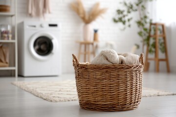 Bright and organized laundry room featuring a washing machine, wicker basket with folded towels, and shelves with home essentials.