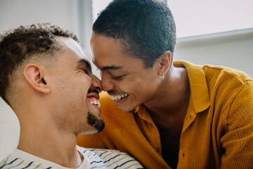 Fototapeta premium Smiling couple embracing at home in loving moment