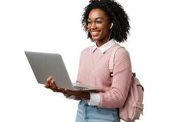 Young African American woman smiling confidently, holding silver laptop, adjusting round glasses, pink sweater, blue jeans. transparent studio background. Concept of modern education and digital