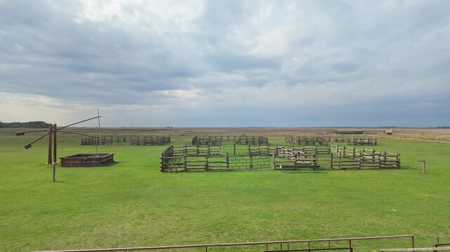 Gorgeous landscape view of the Great Plain with a traditional draw well and empty corral on Hortob&aacute;gy in Hungary.