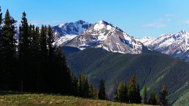 Spring summertime morning Conundrum Castle Peak AJAX Aspen Mountain Little Annie Trailhead aerial drone Castle Creek Maroon Bells Wilderness snow covered Rocky Mountains Ashcroft sunny blue sky upward