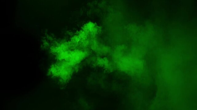 A thick cloud of green toxic smoke bursts and swirls on a black background, horror or fantasy concept for a magical or poisonous effect