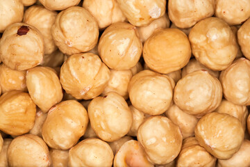Heap of shelled hazelnuts, top view close-up