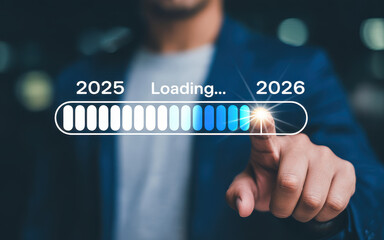 Progress and transition from 2025 to 2026 concept. A person pointing to loading bar transitioning from 2025 to 2026, progress, future planning, and new year goals. annual planning and business growth.