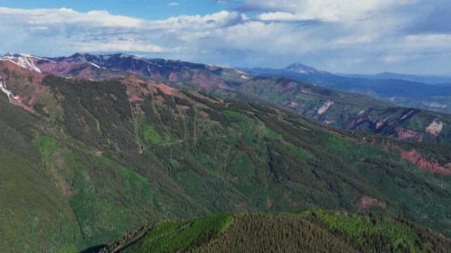 Spring summer Aspen Highlands Little Annie Basin Trailhead AJAX top of Aspen Mountain aerial drone Maroon Bells Wilderness melting snow Rocky Mountains morning sunny blue sky clouds circle right
