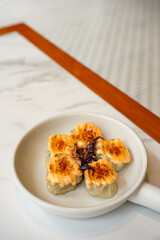 Dimsum with Japanese Mentai Sauce. Served on plate.