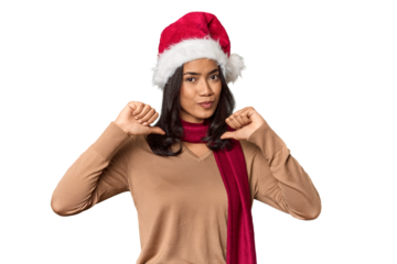 Filipino in Christmas attire and Santa hat feels proud and self confident, example to follow.