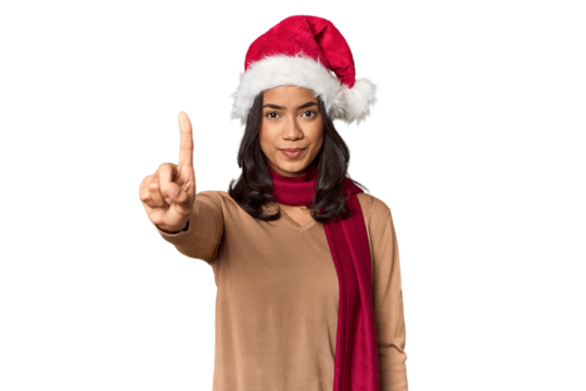 Filipino in Christmas attire and Santa hat showing number one with finger.