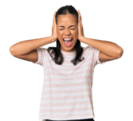 Young Filipina woman covering ears with hands trying not to hear too loud sound.