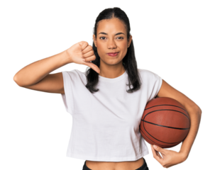 Young Filipino woman with basketball showing a dislike gesture, thumbs down. Disagreement concept.