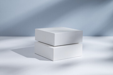 Two white cubes, boxes or podium on a blue background with shadows.