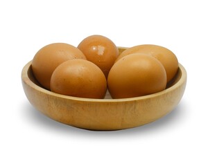 FIve brown chicken eggs in a round wooden bowl, isolated on white background. Minimalist food composition highlighting natural protein source and rustic organic lifestyle.