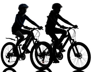 Fototapeta premium Silhouette of two children riding bikes