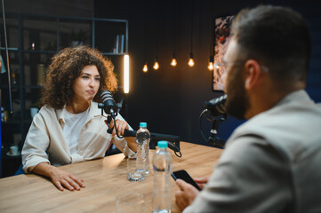 Podcasters recording audio content in studio