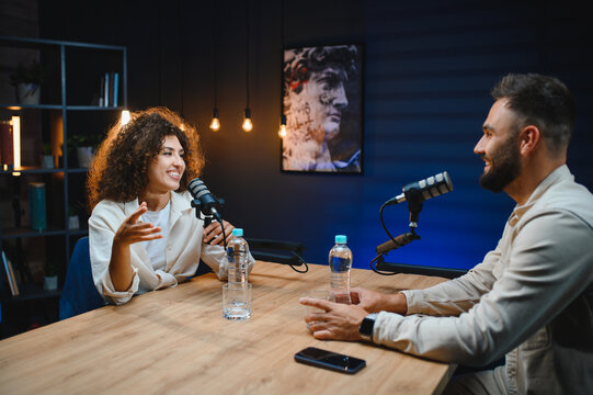 Podcasters recording audio content in modern studio