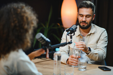 Content creators recording podcast in modern studio
