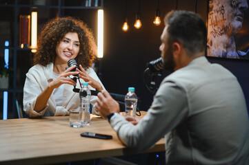 Podcasters recording audio content in professional studio