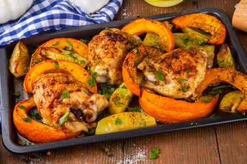 Roasted baked chicken thigh with pumpkin and potato wedges