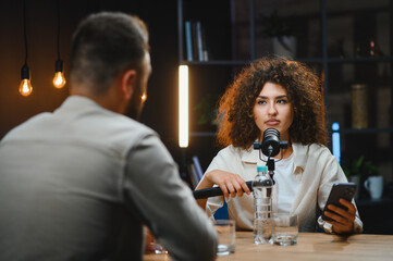 Content creators recording podcast in modern studio