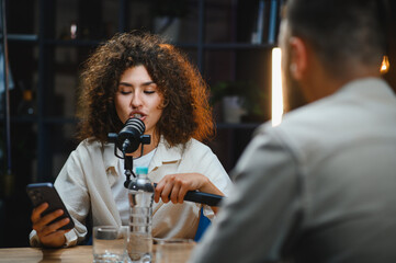Content creators recording podcast in modern studio