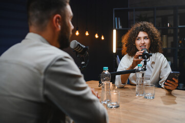 Content creators recording podcast in modern studio