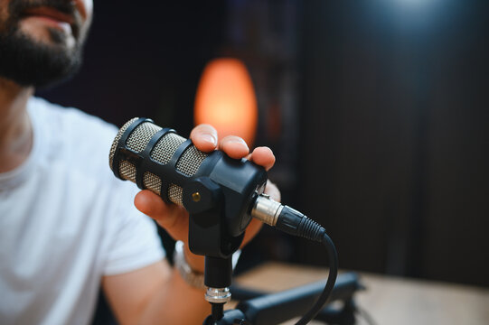 Content creator recording audio podcast with professional microphone - Powered by Adobe