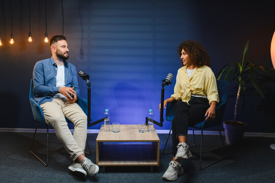 Two content creators recording podcast in professional studio - Powered by Adobe