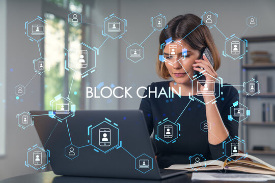 Pensive attractive beautiful businesswoman in formal wear working on laptop at office workplace in background. Using phone. Concept of business education, blockchain cryptocurrency technology.