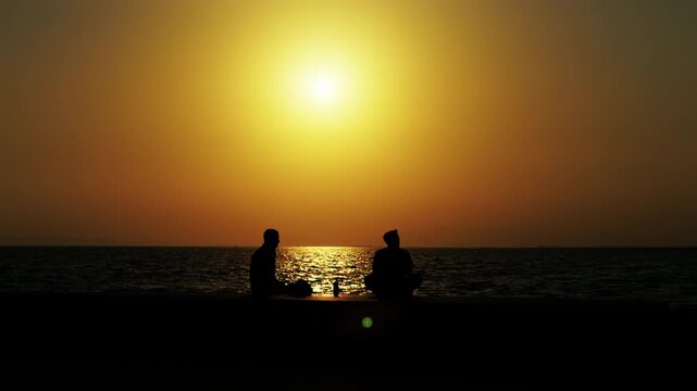 People Silhouette in Sunset Light Near the Sea