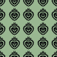 Seamless pattern featuring repeating sacred heart icons in a vector illustration. Black hearts with decorative elements are arranged on a green background, creating a traditional design.