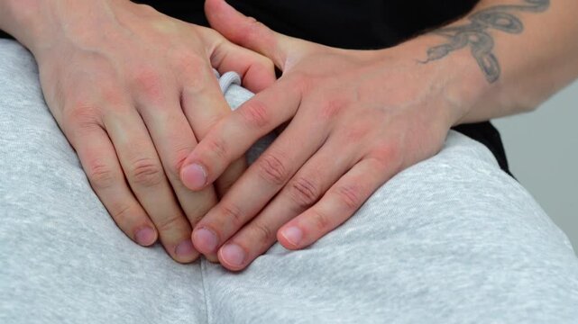 Groin pain in an adult man in gray sweatpants.
Urological problems in a guy.
Men's health and problems with urination in a man