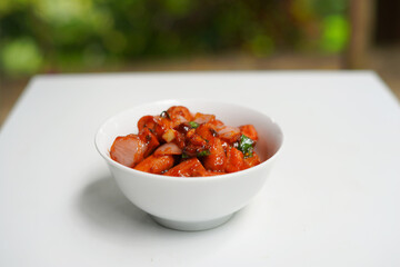 Traditional Devil Sausages in White Ceramic Bowl on White Background.
