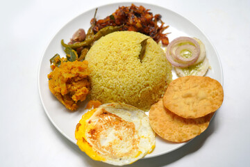 Sri Lankan Traditional Rice and Curry Plate with Omelet on White Background.