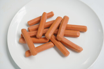 Fresh Sausage Links on White Plate.